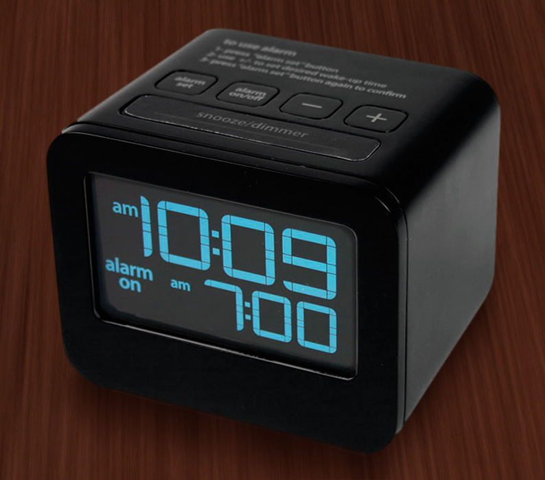A photograph of an alarm clock showing 10:09 am and the alarm on“