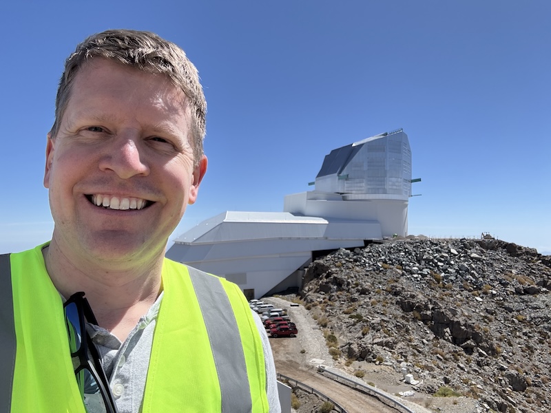 Eric Bellm in front of the Vera C. Rubin Observatory, March 2026.