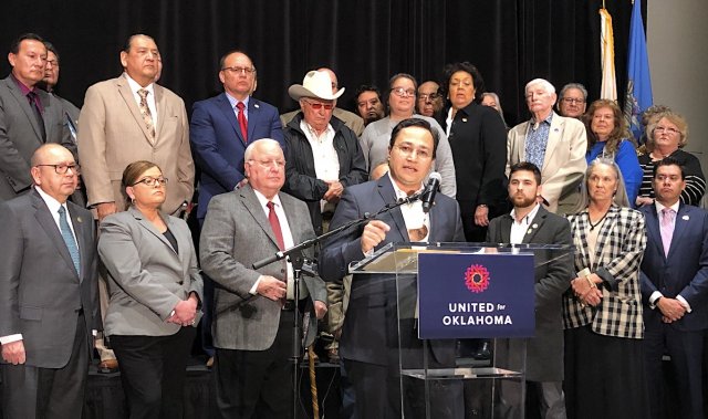Cherokee Nation Principal Chief Chuck Hoskin Jr., along with 50 representatives from over 30 nations, speaks to media at the River Spirit Casino in Tulsa, Oklahoma, on Thursday, Dec. 19, 2019. 