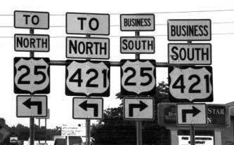 4 highway signs, all different directions