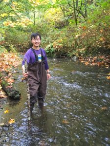 Student scientist working in the field collecting water samples