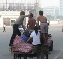 photo of a migrant pedaling a pedicab in south China