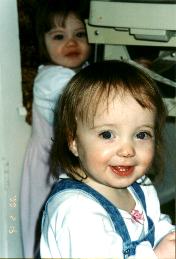 Laura smiles with Alli in the back