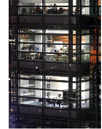 image of office workers in a building at night