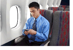 image of a man using a mobile phone on an airplane