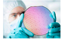 image of man with gloves holding a silicon chip