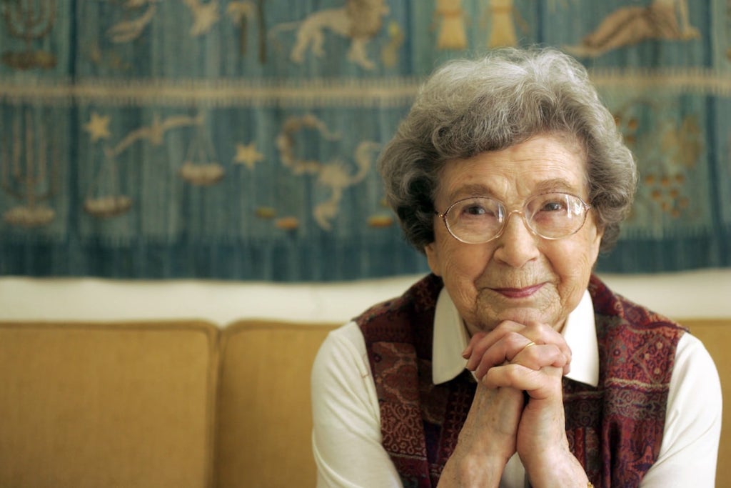 A photograph of Beverly Cleary smiling on a couch.