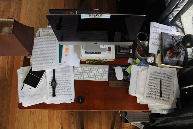A top down photograph of a messy desk