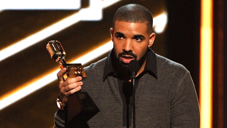 Drake holding a Grammy.