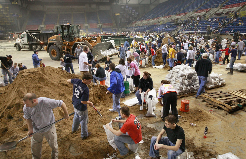 Volunteers fill sandbags during a sandbagging operation at the Fargo Dome March 24, 2009