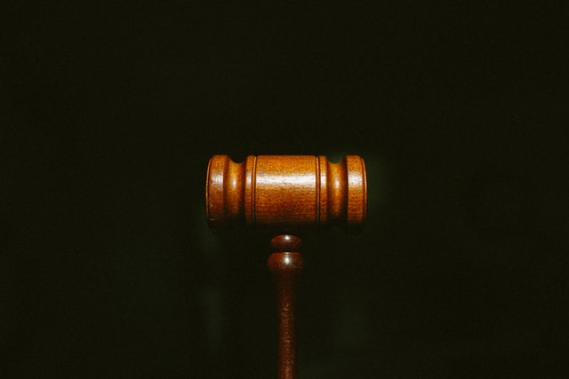 A wooden gavel on a black background