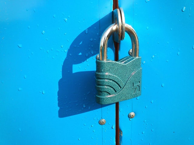 A photograph of a lock on a blue door.
