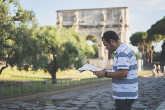 A man looking at a map in Rome, Italy