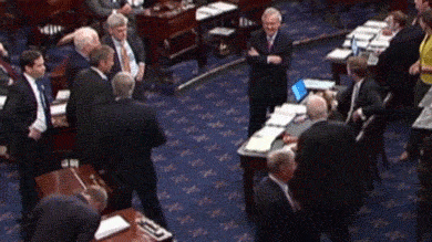 An animated gif showing John McCain making a thumbs down motion on the Senate floor.