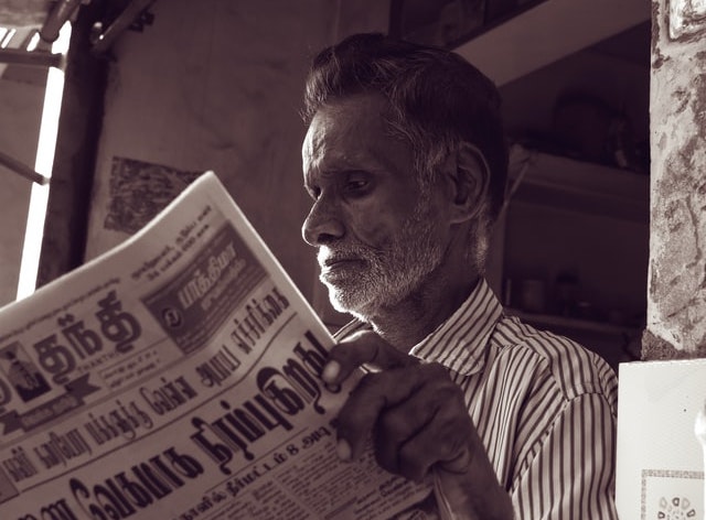 A picture of a man reading a newspaper