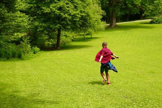 A person running through the grass in a park in Russia