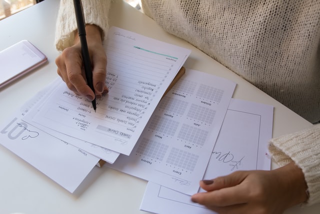 A photograph of a person managing a calendar and to do list.