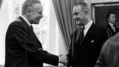 Climate scientist Roger Revelle shakes hands with President Johnson in the Oval Office