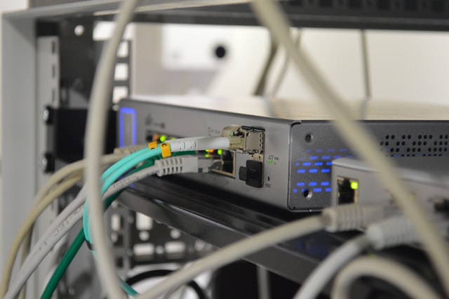 A photograph of a router with ethernet cables plugged in