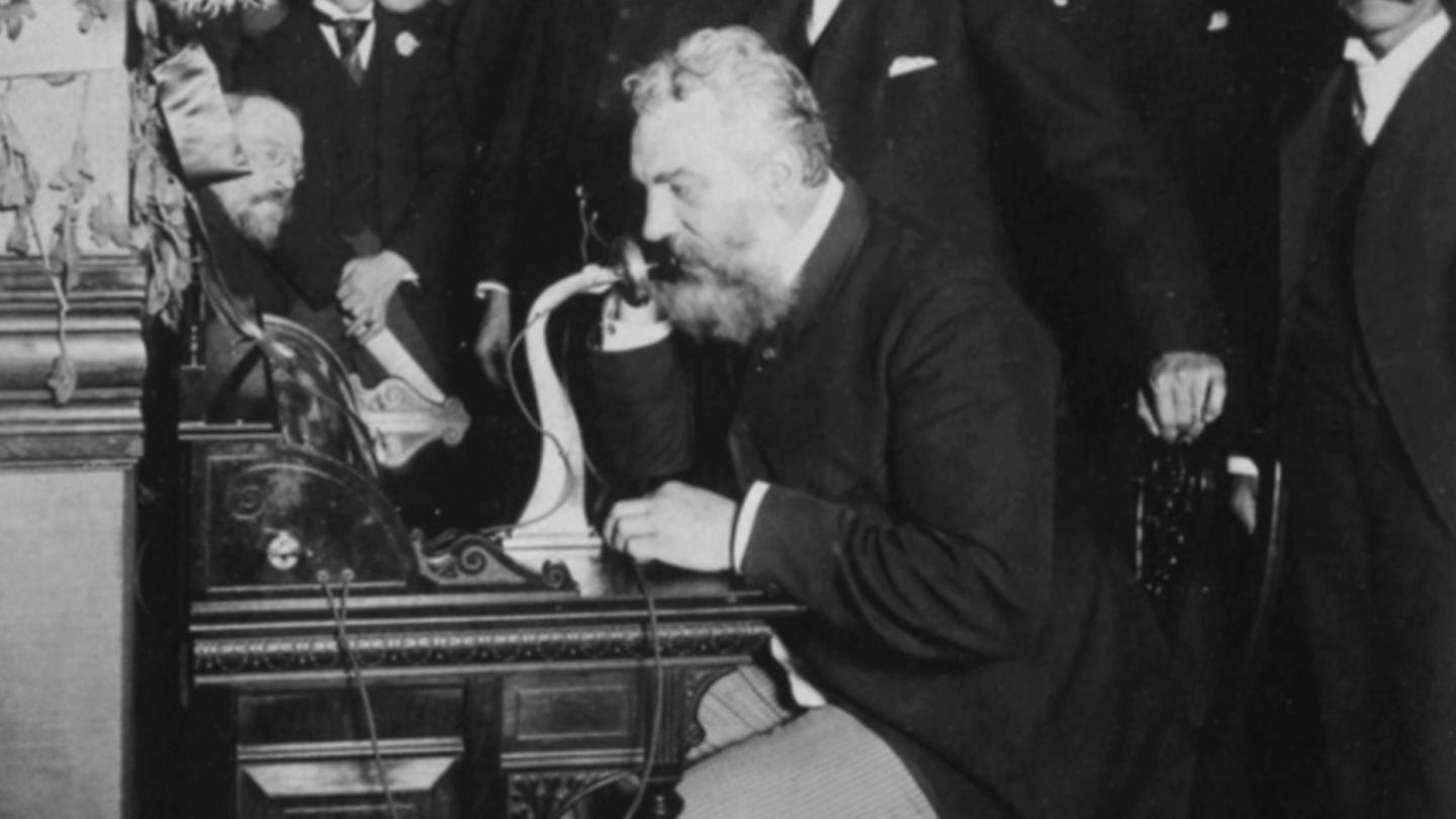Alexander Graham Bell demonstrates the telephone
