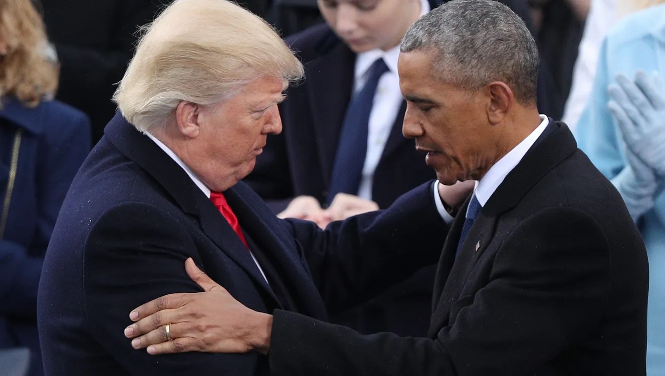 A photograph of Trump and Obama embracing and talking at Trump’s inauguration day