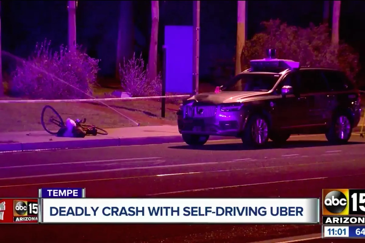 A photograph of a television news story showing the Uber car and mangled bicycle.