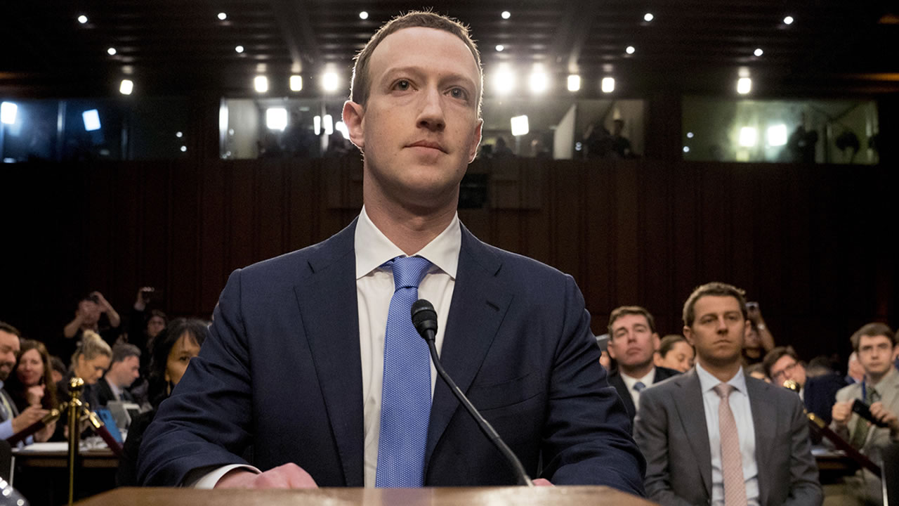 Mark Zuckerberg in a suit testifies to the U.S. Congress.