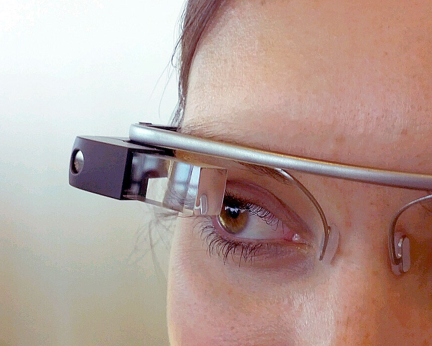 A close up of a person wearing a Google Glass device