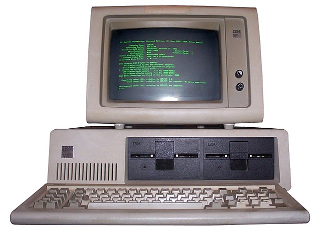 An IBM PC with a green monochrome screen and a grid of fixed-width font.