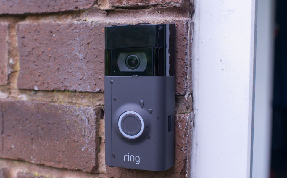 A photograph of a Ring Doorbell mounted on a brick wall.