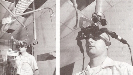 A picture of someone using Ivan Sutherland’s first virtual reality headset, mounted from the ceiling.