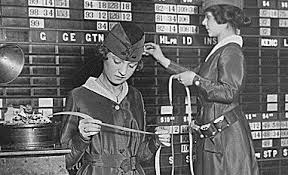 Two women reading ticker tape at the New York Stock Exchange.