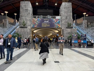 Two imposing marble columns, a dimly lit hallway, and a hundred attendees swarming.