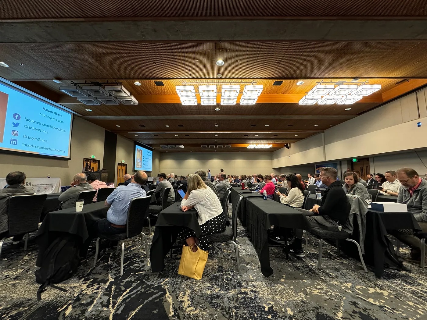 A wide shot of seven rows of seating with more than 300 attendees.