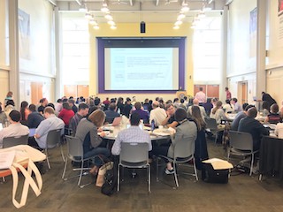 A photograph of the ICER 2017 attendees viewing a talk.