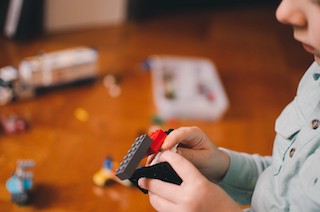 A child assembling legos.