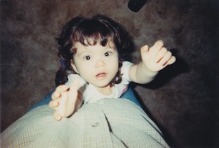 My daughter at age 2, asking to be held.