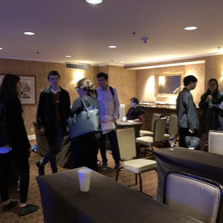 A photograph of attendees chatting after the workshop.