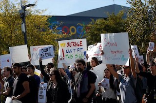 A group of Google protesters outside a Google building, 'My outrage can't fit this sign.'