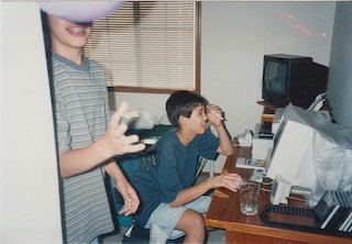 A photograph of adolescent Amy programming at her computer.