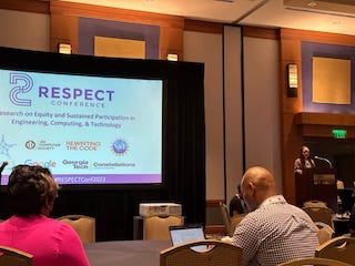 A slide showing "RESPECT conference" and Tamara Pearson at a podium speaking to the large room.