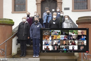 A photograph of the in-person Dagstuhl attendees with a screenshot of the virtual attendees in Zoom.