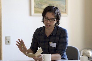 A photograph of me reading from notes at a Dagstuhl workshop.