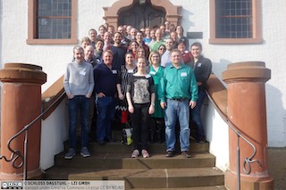 A photograph of the attendees of the Dagstul workshop standing on the stairs.