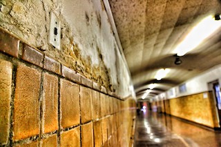 A photograph of a crumbling, dirty school hallway of a school in New Jersey.