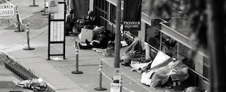 A black and white photo of homeless people in Pioneer Square.