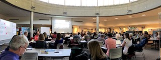 A panorama of the STEM pre-service teacher preparation workshop showing several faculty in conversation.